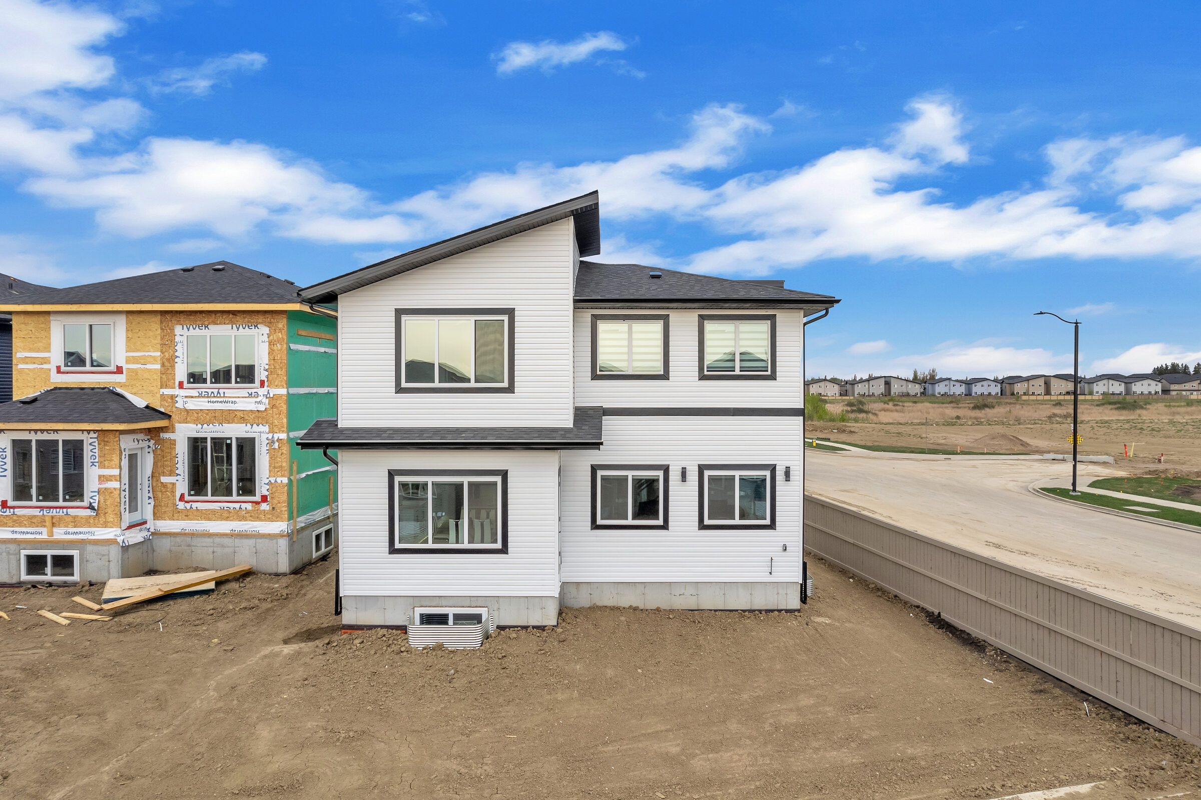 Aerial view of walkout backyards backing onto the pond reserve in Woodbend, Leduc