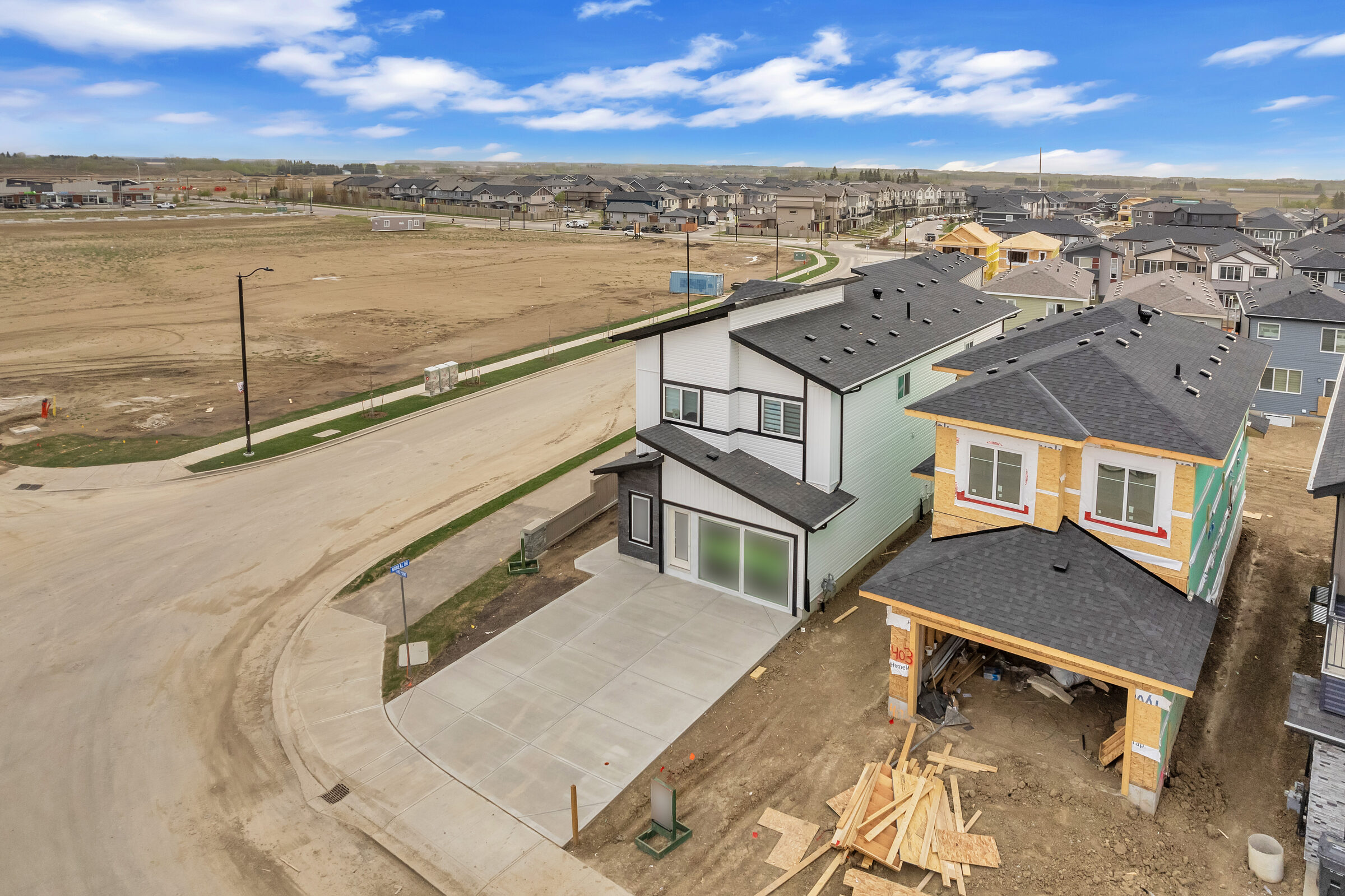 Aerial view of New Valley Homes walkout lots backing onto the Woodbend pond reserve, Leduc